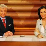 Foto de Renato Machado e Renata Vasconcellos na bancada do jornal.